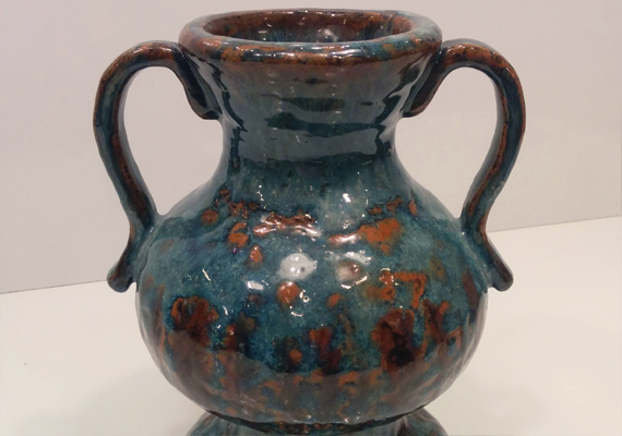 A clay vase made using coiling.